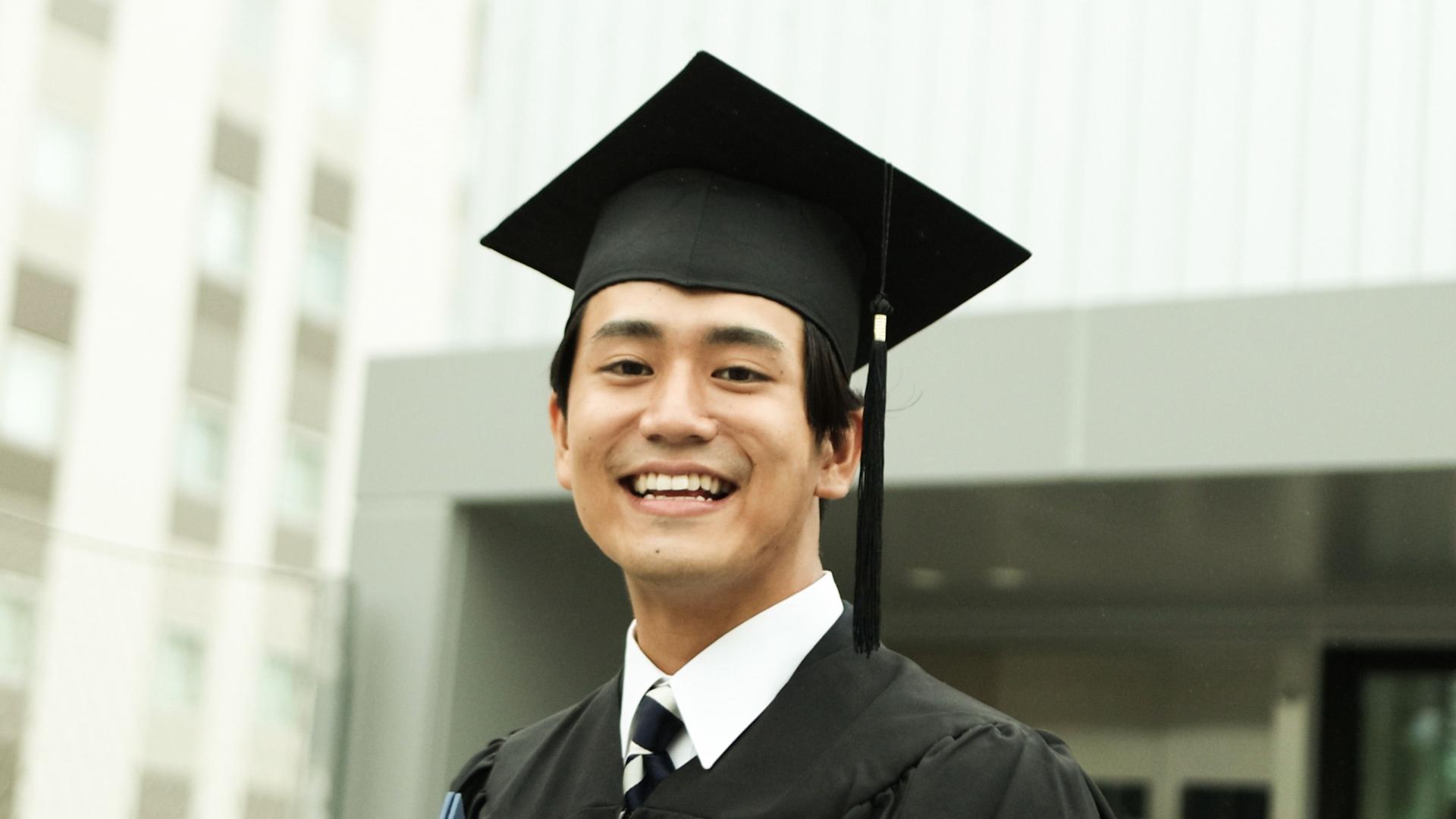 Portrait of Happy asian graduate student